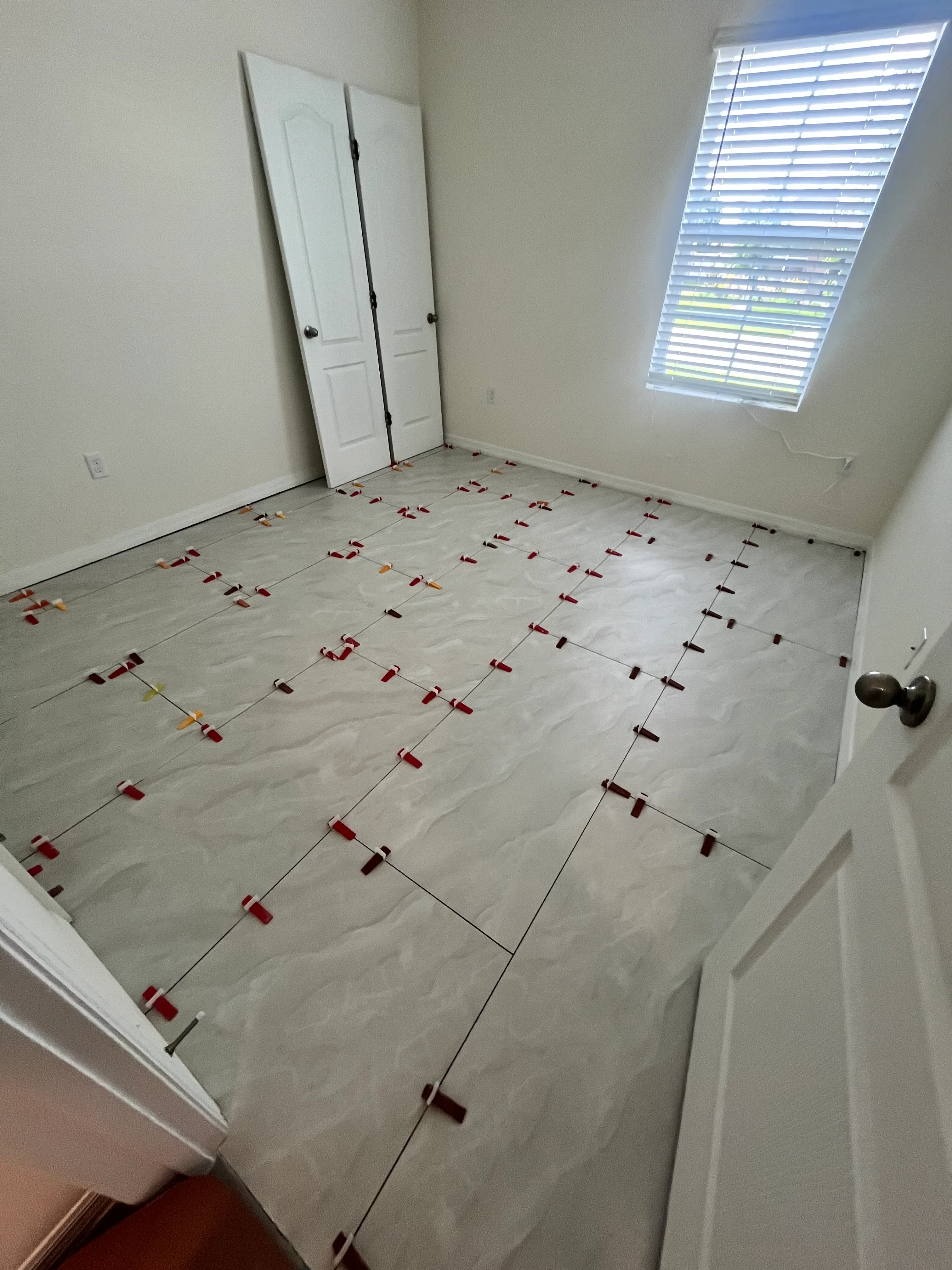 Bedroom 1 tile flooring installation in process, wide angle taken from the window, Wind Meadows South, Bartow, FL