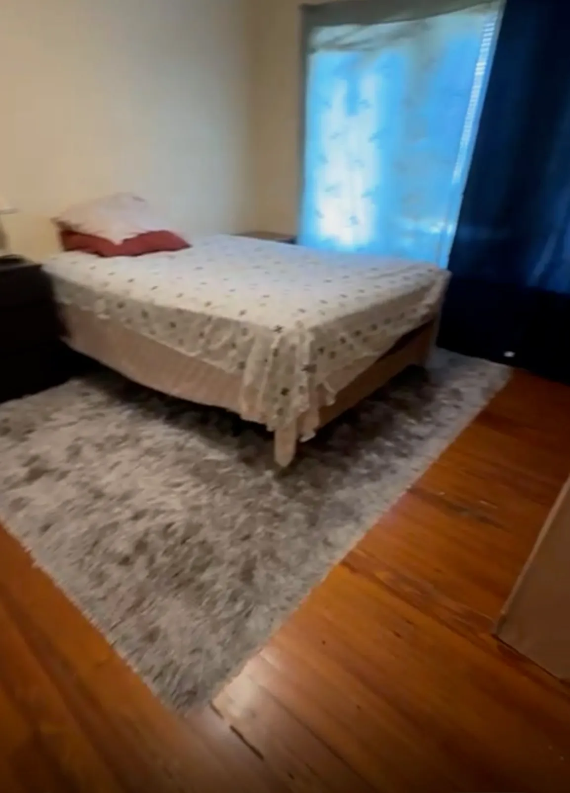 Bedroom with damaged wood flooring before LVP installation in Lake Hunter Terrace, Lakeland, FL