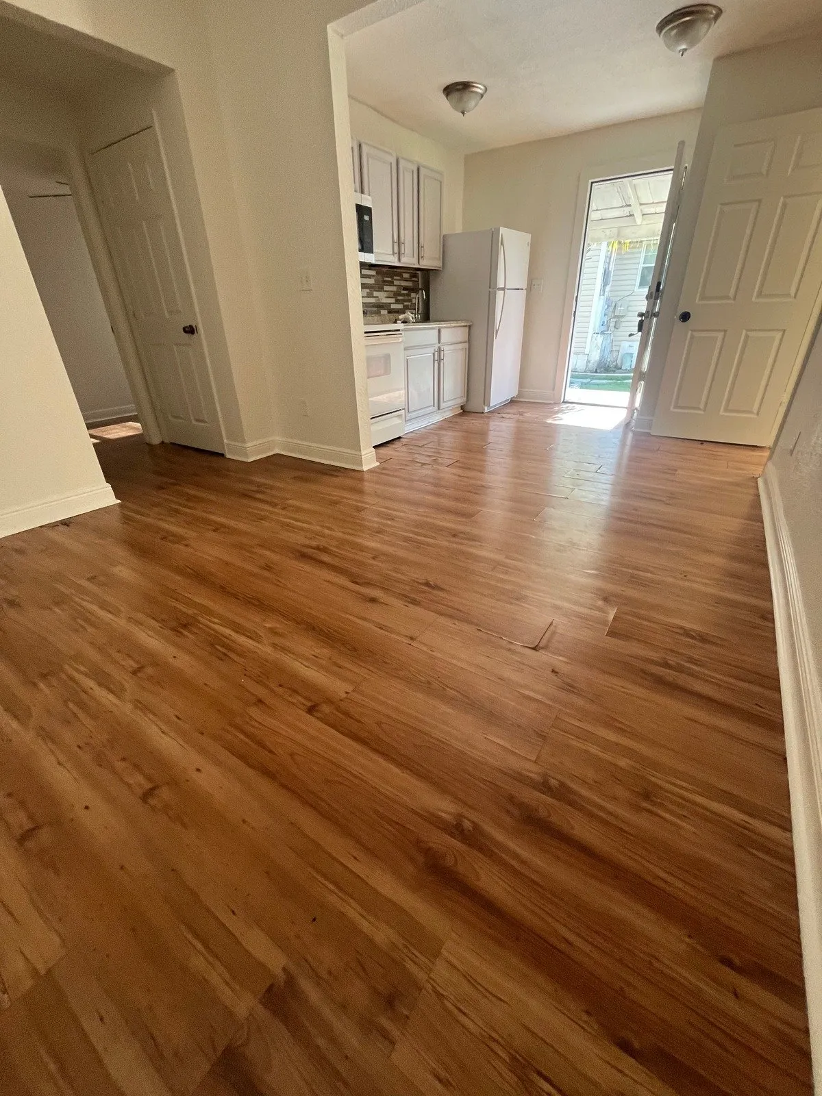 Living room and kitchen before laminate flooring installation in Tampa Heights, Tampa, FL