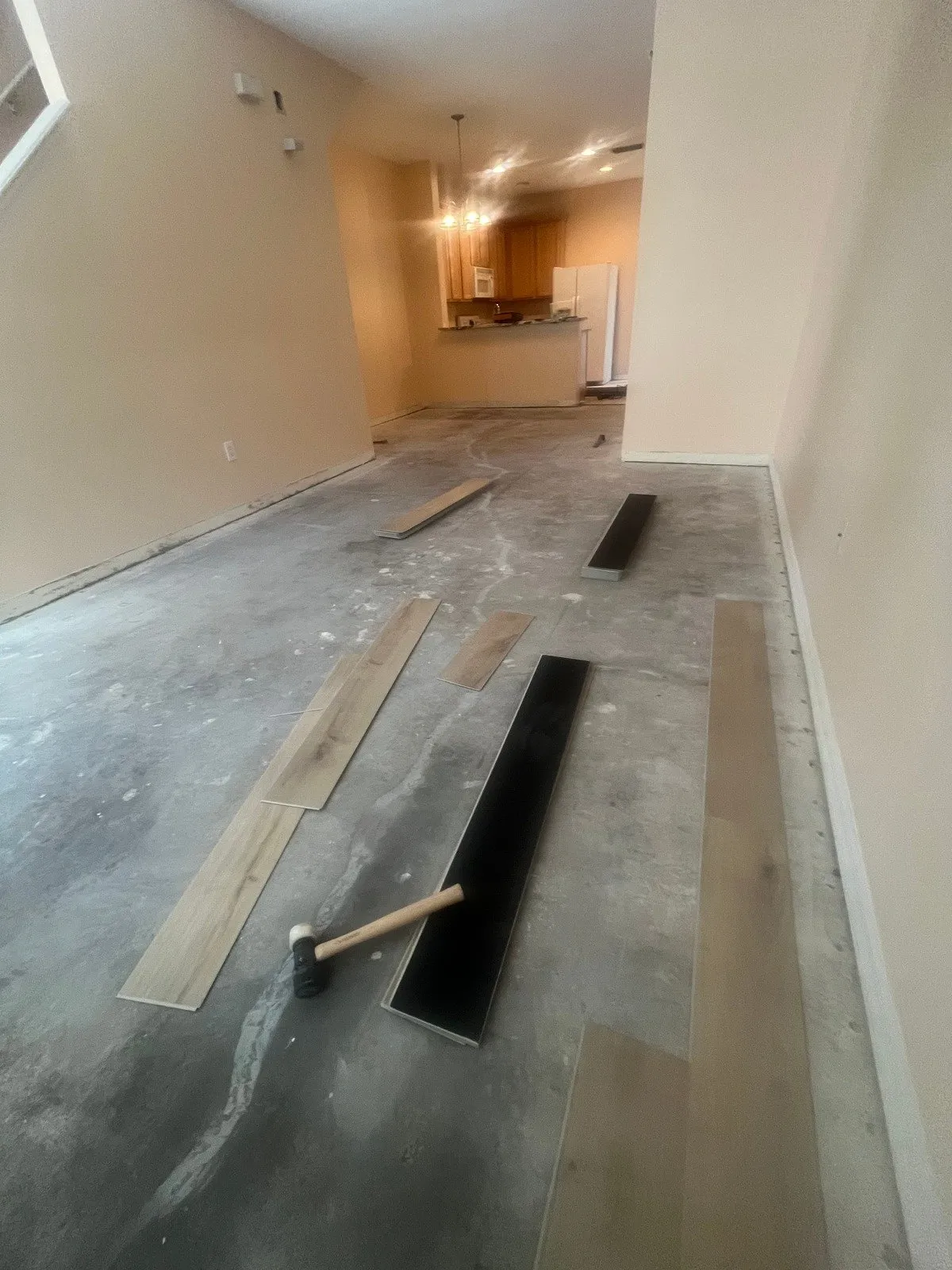 Living room and kitchen before LVP flooring installation in Carrollwood, Tampa, FL