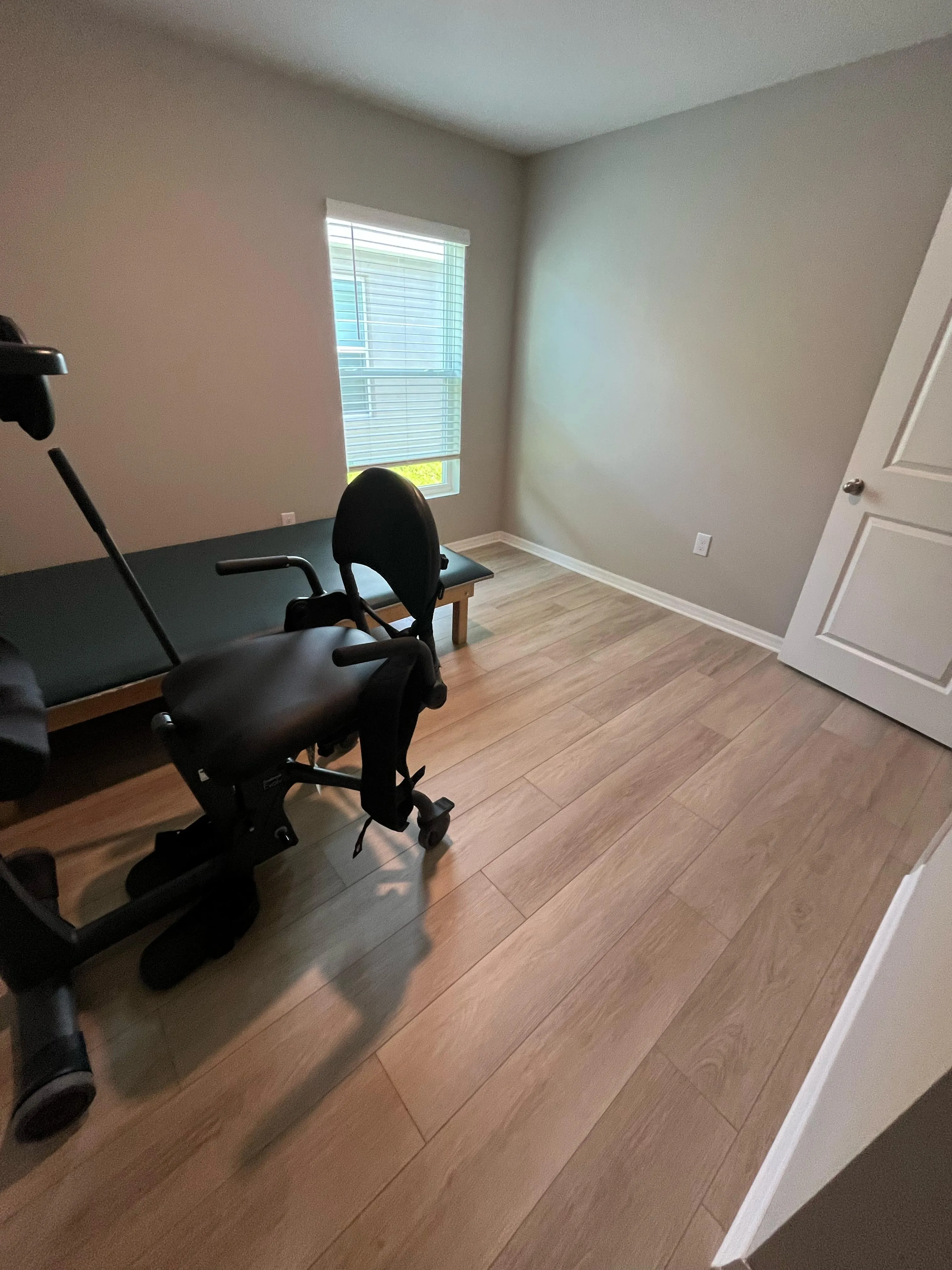 Second bedroom doorway view after laminate flooring installation in Brandon, FL